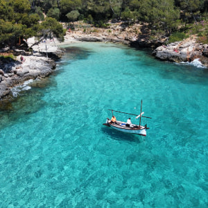Cala Serena Mallorcan llaüt in turquoise blue waters